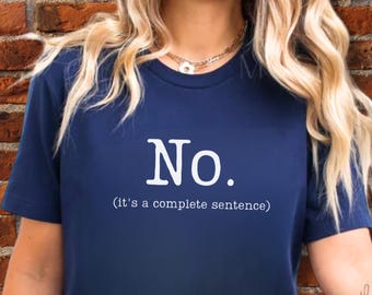 May include: Dark blue t-shirt featuring the word "No." in white, with the text "(it's a complete sentence)" underneath. The top has a round neck and short sleeves.