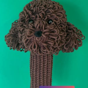 Puede incluir: Una funda para la cabeza del palo de golf marrón hecha a mano con forma de cabeza de perro. La funda está hecha de hilo y tiene ojos negros y una nariz negra. El texto "3 Wood / Fairway Wood" está en la parte superior y "Already Made Ready to Ship" en la inferior.