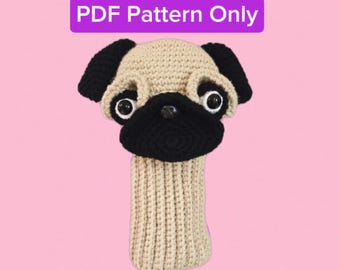 May include: A beige, black, and white crocheted pug dog head cover with large eyes and a black nose. The cover has a long, ribbed beige neck. Text at the top reads "PDF Pattern Only".