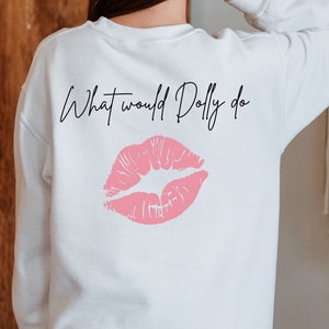 May include: White sweatshirt with the text "What would Dolly do" and a pink lipstick print on the back.