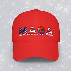 May include: A bright red baseball cap featuring the text MAGA in large letters. The M is patterned with the American flag, the A is striped like the flag, the G is a rainbow gradient, and the second A is striped. Below is MAKE AMERICA GAY AGAIN.