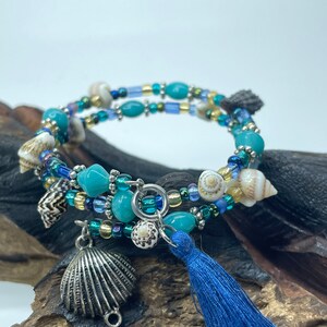 BEACH COMBER: Bracelet filled with Sea Shells, Aqua Beads, Czech Glass Beads, Silver Metal Spacers - finished with a Clam and Tassel.