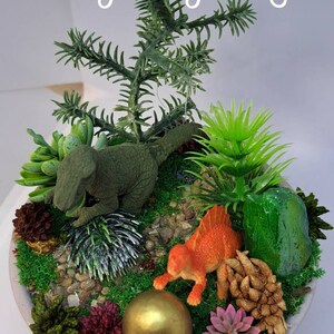 Cute Dinosaur themescape garden with green crystal and prehistoric greenery. Imagination play, creative play for kids. Gift ideas for boys
