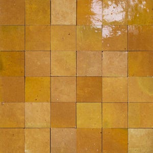 Peut inclure: Une grille de carreaux carrés dans des tons de jaune et d'or. Les carreaux ont une finition brillante, reflétant la lumière. L'arrangement suggère un motif adapté aux revêtements de sol ou aux décorations murales.