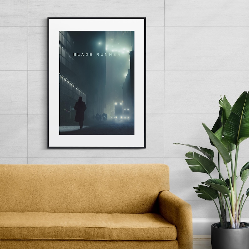 May include: A black and white poster with the text "BLADE RUNNER" in white letters. The poster features a silhouette of a person walking down a foggy street at night.