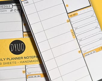May include: A black and white daily planner notepad with yellow accents. The notepad has a section for "Today's Schedule" with columns for "Time", "Activity", and "Important". There is also a section for "To Do" with a space for writing and checkboxes. The notepad has the text "DYUO Daily Planner Notepad 50 Sheets - Handmade" printed on the front.
