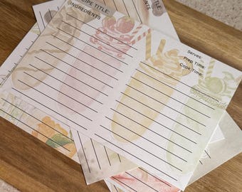 May include: A set of four recipe cards with a milkshake theme. Each card has a watercolor background with a milkshake illustration and lined spaces for writing down the recipe title, ingredients, serves, prep time, and cook time.