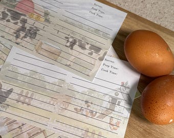 May include: A set of four recipe cards with a farmhouse theme. Each card has a different illustration of a farm scene with cows, chickens, and a barn. The cards have lined spaces for writing down the recipe title, ingredients, servings, prep time, and cook time.