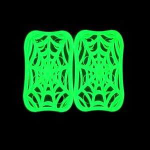 May include: Two neon green, rectangular-shaped coasters with a spiderweb design. The coasters are symmetrical and glow brightly against a black background. The spiderweb pattern is intricate and detailed.
