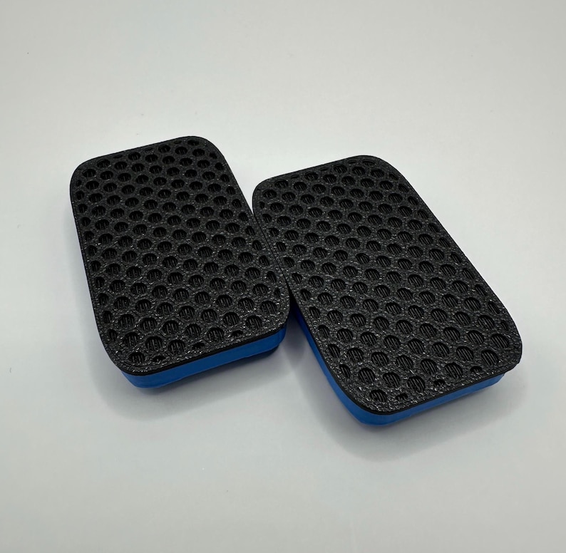 May include: Two black rectangular air filters with a blue trim. The filters have a honeycomb pattern.