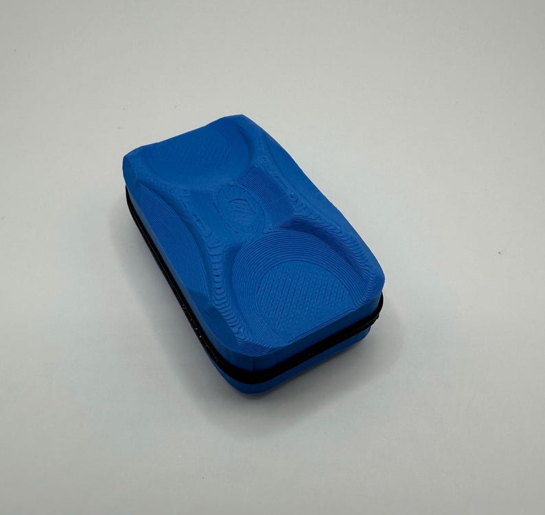 May include: A blue magnetic whiteboard eraser with a textured surface and a black trim.