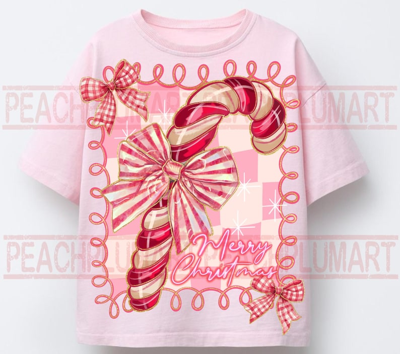 May include: A light pink t-shirt featuring a candy cane design with red and white stripes and a large bow. The words "Merry Christmas" are written in cursive. The design is framed with a pink border and two small bows.