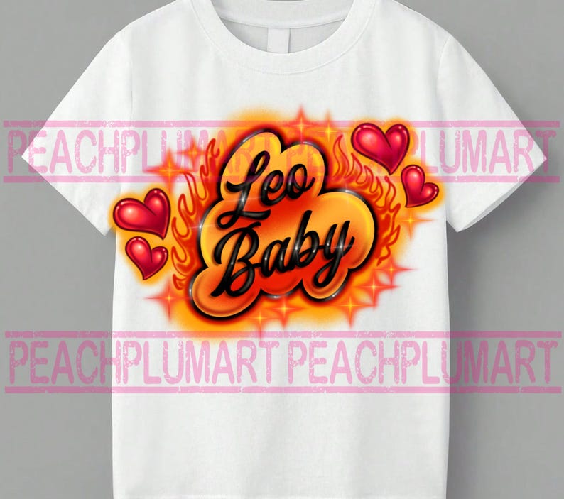 May include: White t-shirt with a colorful airbrushed design. The design features the words "Leo Baby" in black script, surrounded by orange flames, red hearts, and starbursts. A fun and vibrant graphic tee.