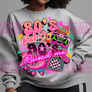 May include: A gray sweatshirt with a graphic design featuring the text "80's Baby 90's Raised Me" in pink and neon pink lettering. The design also includes a cassette tape, a boombox, roller skates, and a television.
