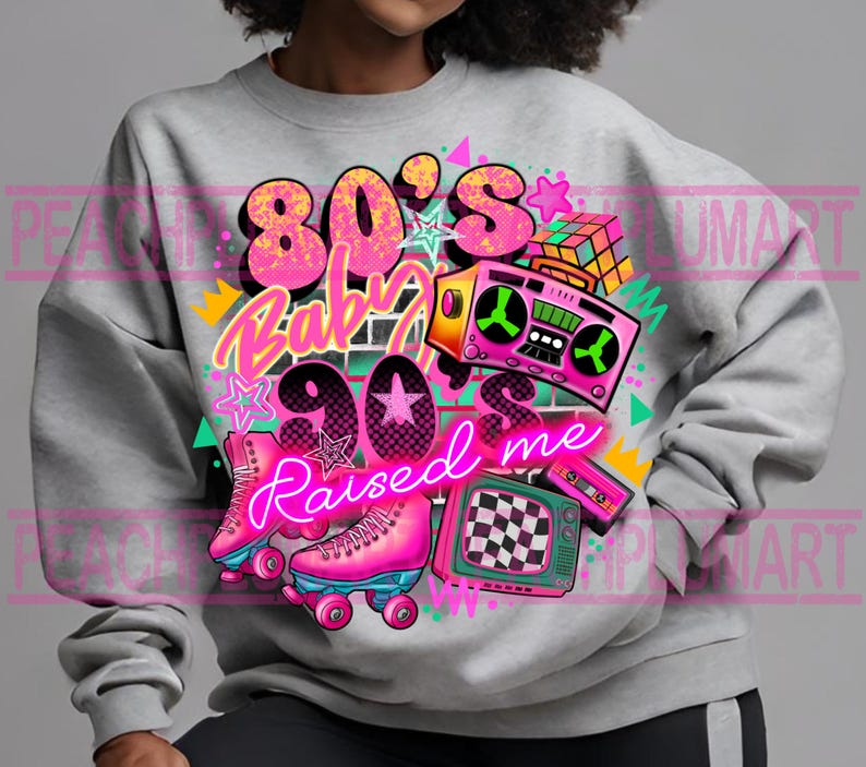 May include: A gray sweatshirt with a graphic design featuring the text "80's Baby 90's Raised Me" in pink and neon pink lettering. The design also includes a cassette tape, a boombox, roller skates, and a television.