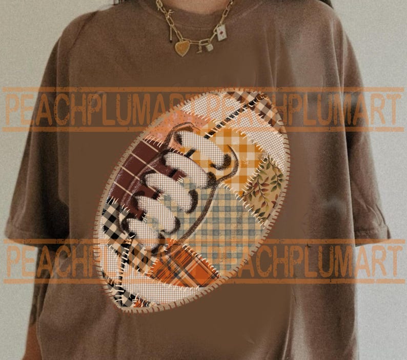 May include: Brown t-shirt featuring a patchwork football design. The football is made of various patterned fabrics in shades of brown, orange, and cream. The shirt has short sleeves and a relaxed fit, suitable for casual wear.