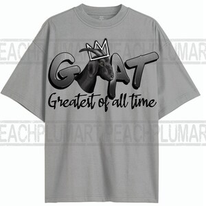May include: A gray t-shirt with a black and white graphic of a goat wearing a crown. The text "GOAT Greatest of all time" is printed below the goat.