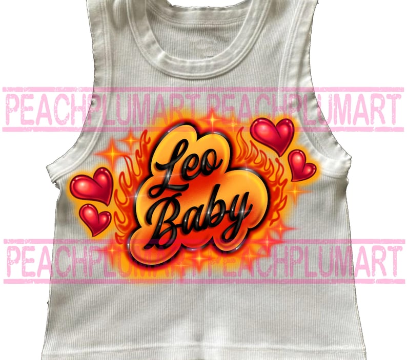 May include: White ribbed tank top with an airbrushed design. The design features the words "Leo Baby" in black script, surrounded by orange flames, stars, and red hearts. The tank top is sleeveless.