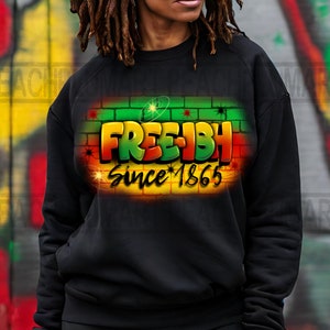 May include: Black sweatshirt with a graphic print of a brick wall with the words "FREE-ISH Since 1865" in green, red, and yellow.