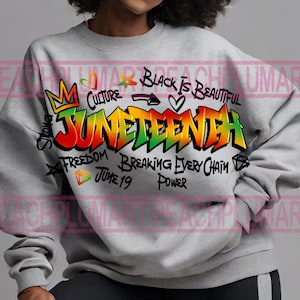 May include: A gray sweatshirt with a colorful Juneteenth graphic. The design includes the word "Juneteenth" in vibrant graffiti-style lettering, along with phrases like "Black is Beautiful," "Freedom," and "Breaking Every Chain."
