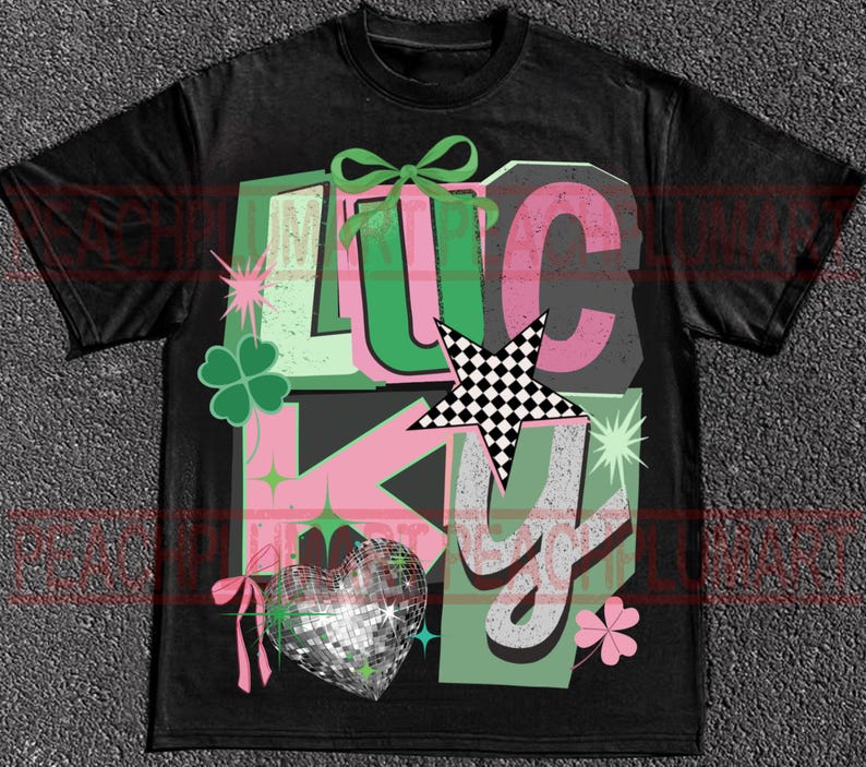 May include: Black t-shirt with a graphic design that says "LUCKY" in green, pink, and white. The design includes a four-leaf clover, a disco ball heart, and a checkered star.