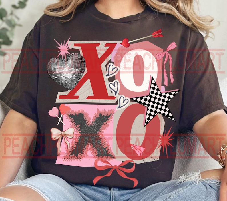 May include: A dark brown t-shirt featuring a Valentine's Day design with the letters "XO" in red. The design includes a disco ball heart, a checkered star, hearts, bows, and an arrow. The overall theme is love and romance.