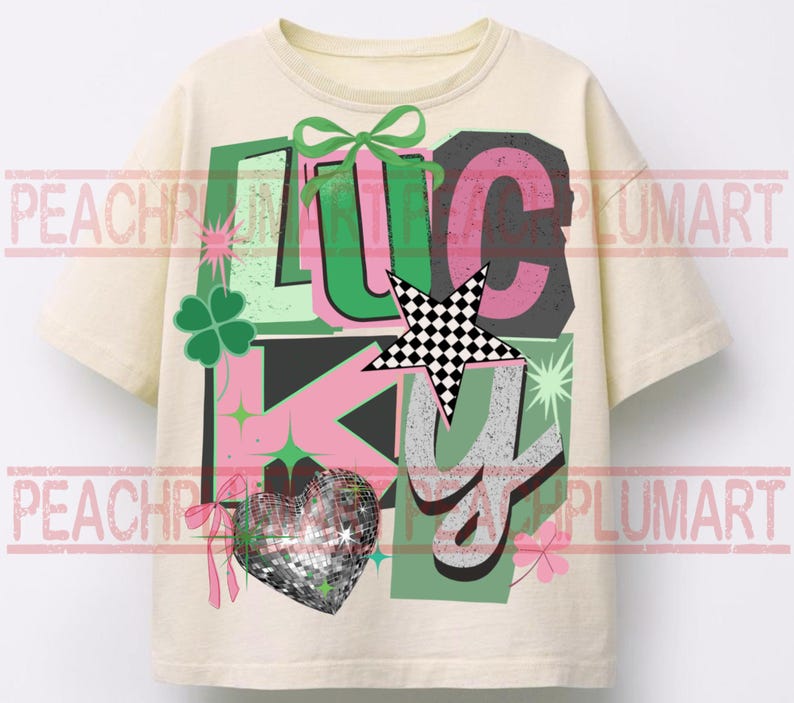 May include: Cream-colored t-shirt with the word "LUCKY" in a colorful, layered design. The design includes a green bow, a checkered star, a disco ball heart, and shamrocks. The letters are in pink, green, and gray.