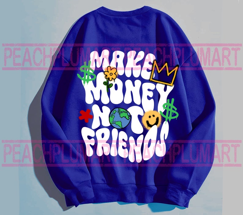 May include: A royal blue sweatshirt with a white graphic that says "Make Money Not Friends" in a retro font. The graphic also includes a crown, a flower, a smiley face, a dollar sign, and a globe.