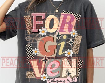 May include: Dark gray t-shirt with the word "FORGIVEN" in a colorful, retro design. The design includes daisy flowers, leopard print, and the text "Ephesians 4:32".