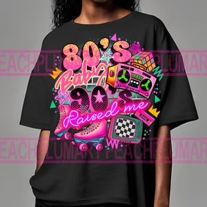 May include: Black t-shirt with a graphic design featuring a pink and blue roller skate, a boombox, a Rubik's cube, and the text "80's Baby 90's Raised Me".