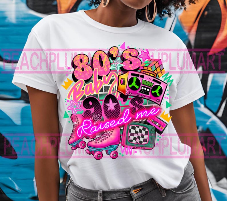 May include: White t-shirt with a graphic design featuring the text "80's Baby 90's Raised Me" in neon pink and blue lettering. The design also includes a boombox, roller skates, a Rubik's cube, and a retro television.