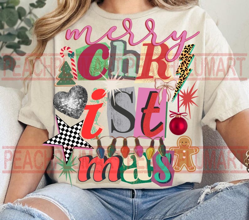 May include: Cream-colored t-shirt with a colorful Christmas-themed graphic. The design includes the words "merry Christmas" in pink, green, and red, along with festive images like a disco ball heart, a star, and a gingerbread man.