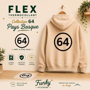 May include: A beige hooded sweatshirt featuring a black circular graphic with the number 64 on the back. The image includes text reading FLEX THERMOCOLLANT, Collection 64 Pays Basque, and icons indicating washability at 30 degrees Celsius, durability, and ease of application.