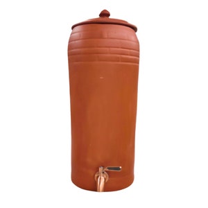 May include: A terracotta water cooler with a lid and a spigot. The cooler is a traditional way to keep water cool and refreshing.