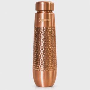 May include: A copper-colored metal water bottle with a smooth neck and base, featuring a textured hammered finish on the main body. The brand name Mittify and a circular logo are printed in a light color on the upper section of the bottle.