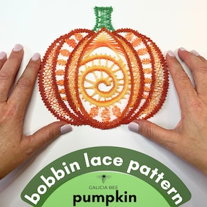 May include: A bobbin lace pattern for a pumpkin, with a green stem and orange and yellow lace. The pattern is called "Galicia Bee Pumpkin" and is on a green background.