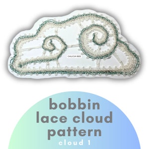 May include: A white bobbin lace cloud pattern with a green border. The lace is in the shape of a cloud with a spiral design in the center. The text "GALICIA BEE" is written on the lace. The text "bobbin lace cloud pattern cloud 1" is written below the lace.