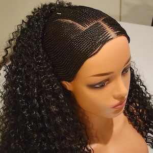 May include: A black wig with a braided base and curly hair extensions. The wig is on a mannequin head.