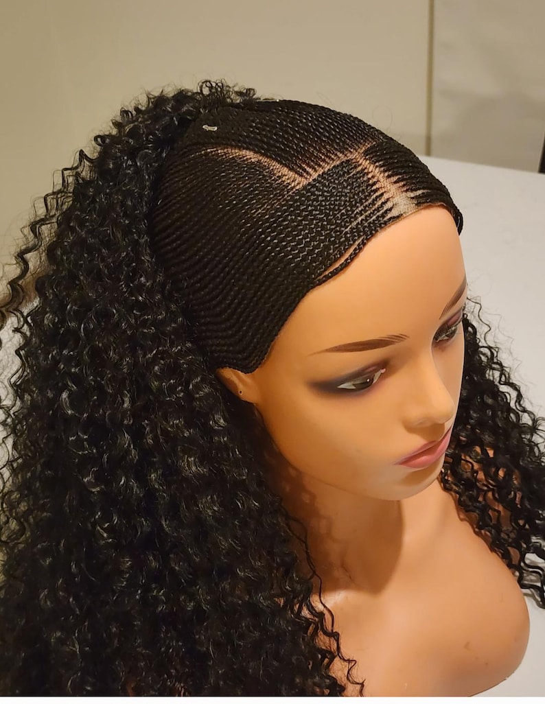 May include: A black wig with a braided base and curly hair extensions. The wig is on a mannequin head.
