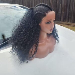 May include: A black curly human hair wig with a braided lace closure. The wig is styled with a middle part and the braids are in a cornrow pattern.