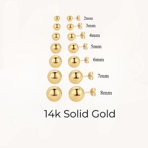 May include: A set of 14k solid gold ball stud earrings in various sizes, ranging from 2mm to 8mm. The earrings are displayed in pairs, with the size of each pair labeled in millimeters.