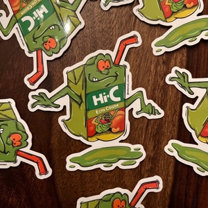 May include: A collection of Hi-C Ecto Cooler stickers. Each sticker features a green cartoon character with a juice box body, orange eyes, and a red straw. The Hi-C logo is visible on the juice box.