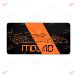 May include: Black rectangular mousepad with an orange diagonal stripe and a line drawing of a race car. The text "MCL 40" is displayed in orange and black.
