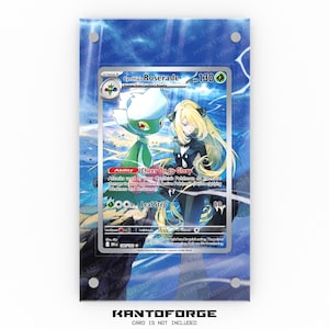 May include: A framed trading card featuring "Cynthia's Roserade" with a green and white floral design and a character illustration. The card is displayed in a clear acrylic frame with a blue and white background. The text "KANTOFORGE" is at the bottom.