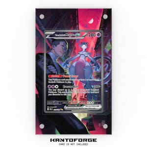 May include: A framed Pokémon trading card featuring Team Rocket's Mewtwo EX. The card is displayed in a clear acrylic case against a vibrant, colorful background. The card's details, including the HP, attack, and abilities, are visible.