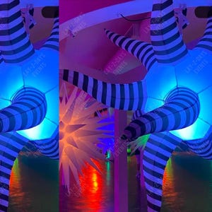 May include: Inflatable, tentacle-like structures with black and white stripes, illuminated with blue light. The structures are part of an event display. The text "LAY-Z-DAYS EVENTS" is visible on the structures.