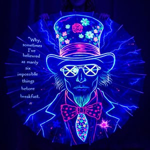 May include: A glowing neon art piece featuring a man in a top hat and glasses, with a quote about believing in impossible things. The hat is decorated with flowers, and the design is outlined in blue and pink.