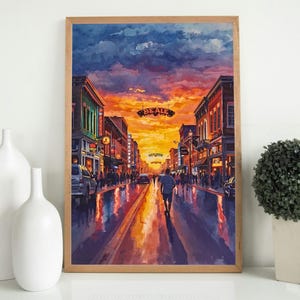 Pode incluir: Uma pintura em aquarela emoldurada de uma rua da cidade ao pôr do sol. A obra de arte retrata uma cena de rua com edifícios, pessoas e carros. O céu é uma mistura de tons laranja, amarelo e roxo, com a palavra "BEALE" em um letreiro.