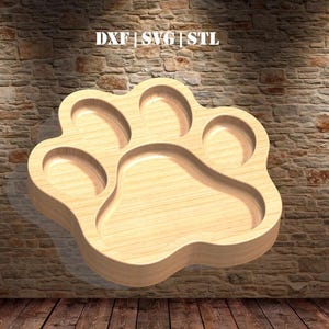 May include: A wooden paw print shaped tray with five indentations. The tray is light brown and has a smooth finish.