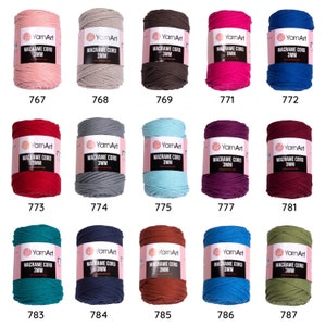 May include: A collection of 15 spools of macrame cord in various colors. Each spool is labeled 'YarnArt Macrame Cord 3MM' and has a corresponding number from 767 to 787.